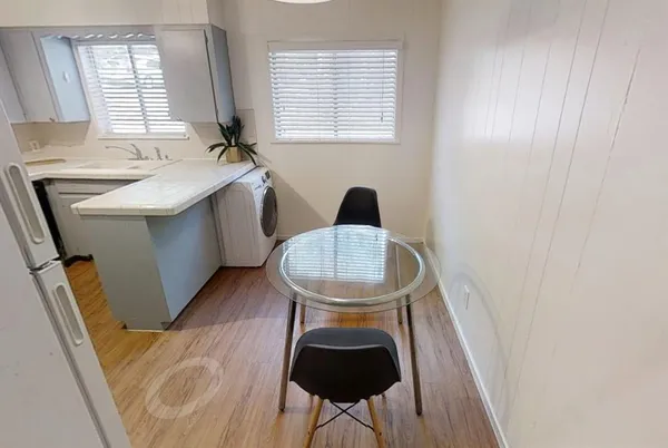 a dining room with furniture and window