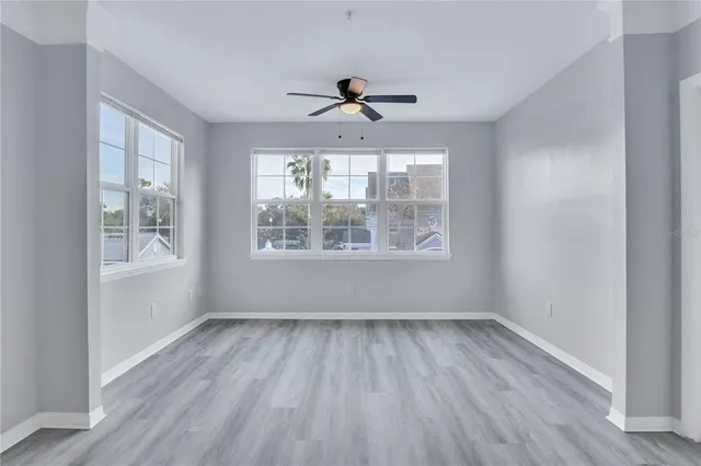 wooden floor in an empty room with a window