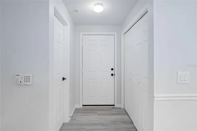 a view of a hallway with wooden floor