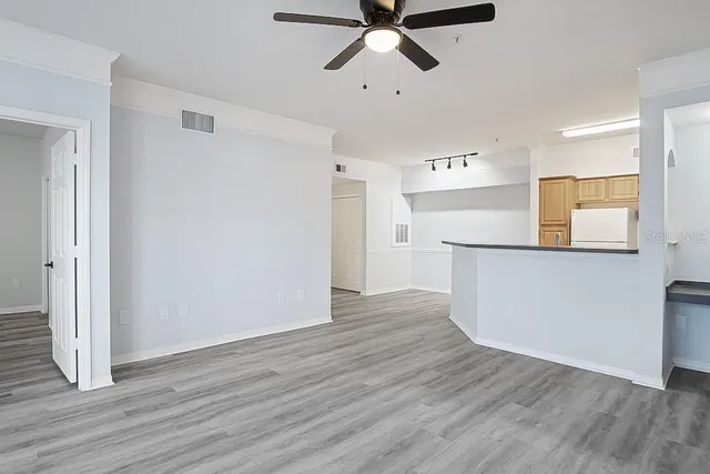 a view of empty room with wooden floor