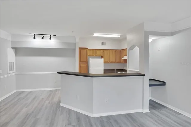 a kitchen with stainless steel appliances a sink and a refrigerator