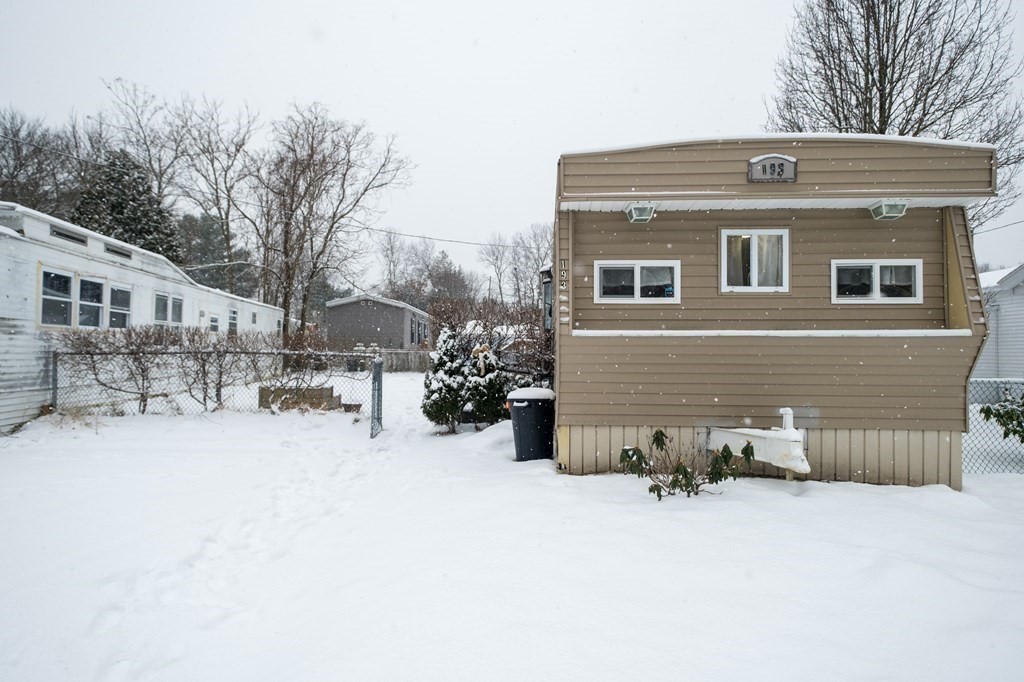 193 Shoreline Drive Tewksbury, MA 01862 - Photo 1 of 19 a front view of a house with a yard covered in snow