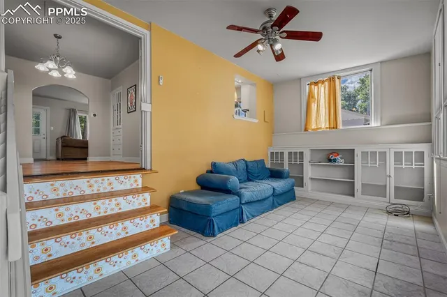 a living room with furniture and a chandelier