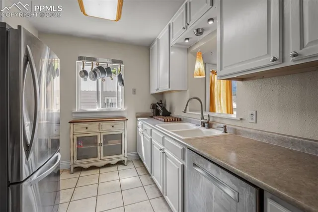 a kitchen with a sink stove and refrigerator