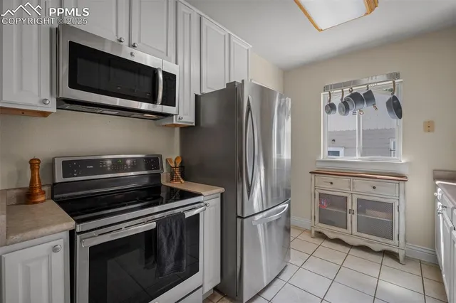 a kitchen with cabinets stainless steel appliances and a counter space