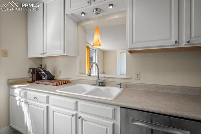 a kitchen with a sink cabinets and a window