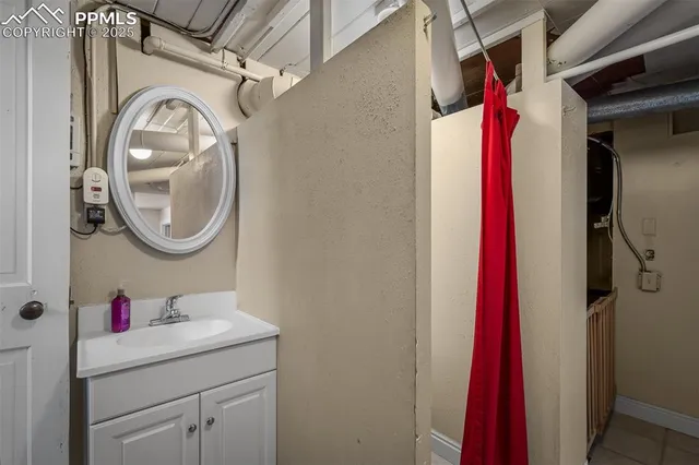 a view of an empty room with wooden floor and windows