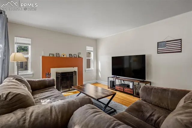 a living room with furniture and a flat screen tv
