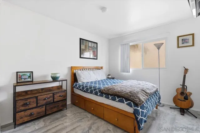 a bedroom with a bed and a dresser