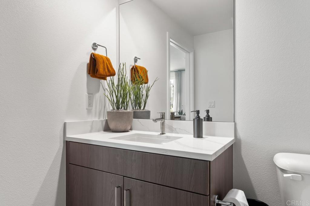 2060 Paseo Belluno, Unit 6 Chula Vista, CA 91913 - Photo 51 of 64 a bathroom with a sink and a mirror
