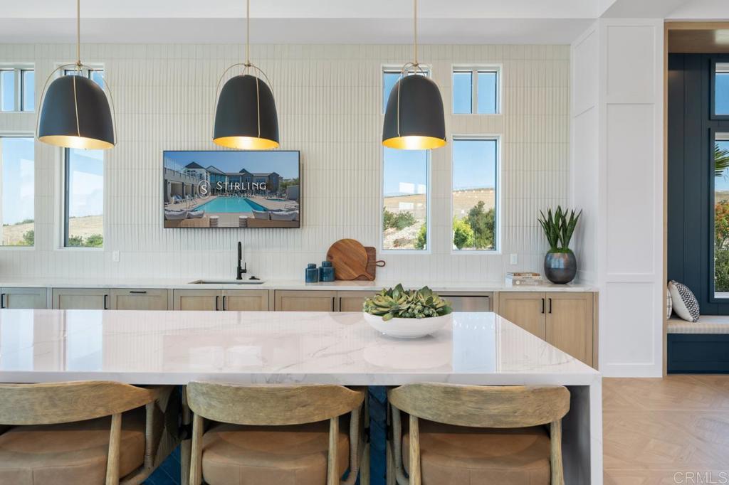 2060 Paseo Belluno, Unit 6 Chula Vista, CA 91913 - Photo 7 of 64 a kitchen with a table a sink and a stove with wooden floor