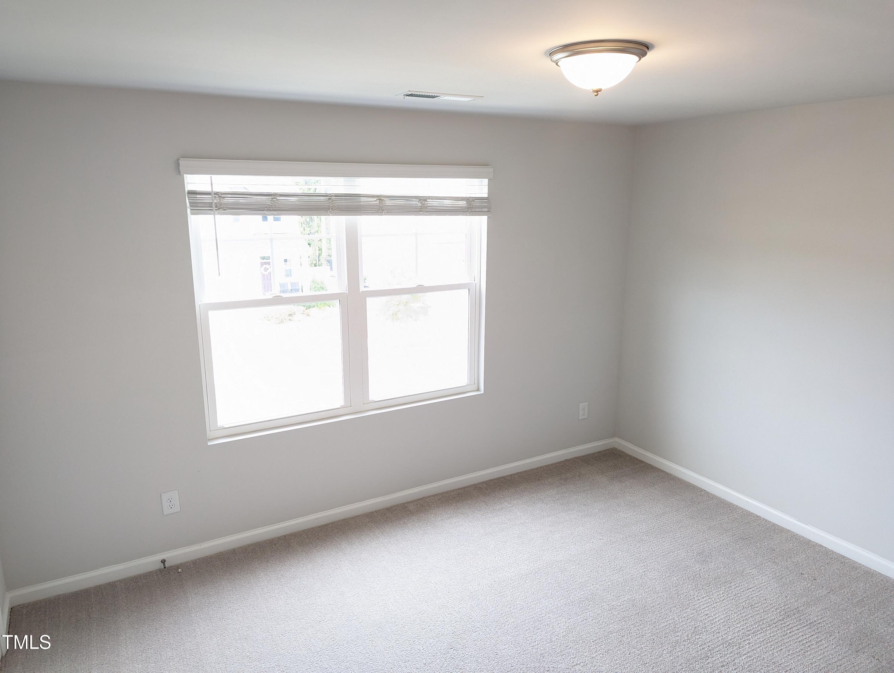 4020 Whitney Peak Drive Raleigh, NC 27616 - Photo 15 of 21 an empty room with a window