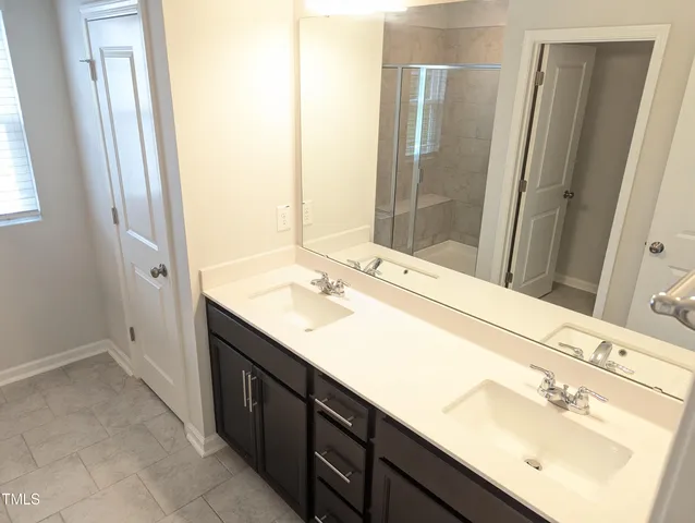 a bathroom with a double vanity sink a and mirror