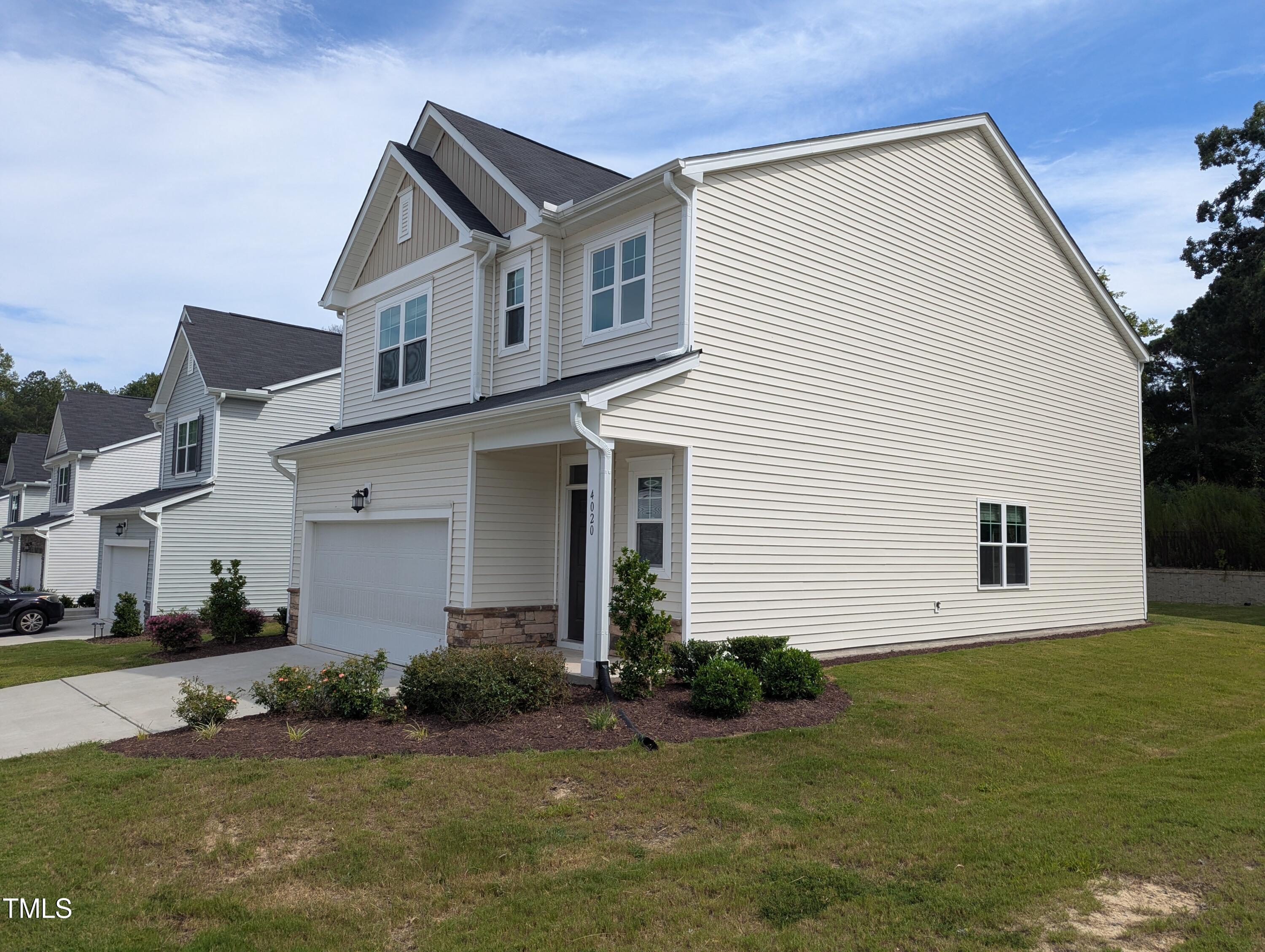 4020 Whitney Peak Drive Raleigh, NC 27616 - Photo 2 of 21 a front view of a house with a yard and garage