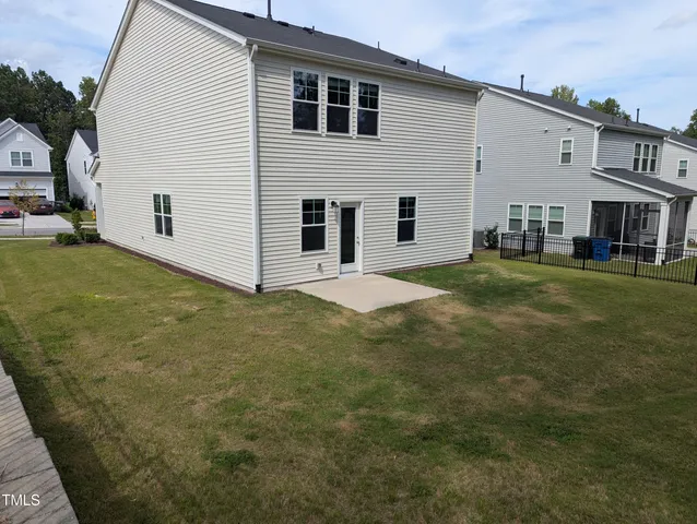 a view of a house with backyard and porch