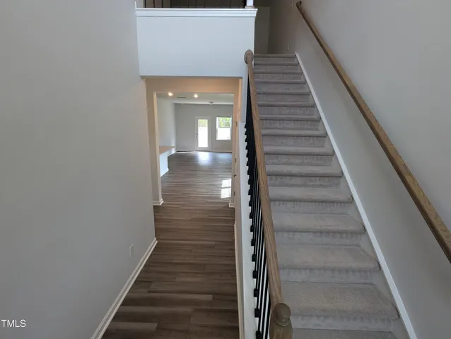 a view of entryway and gallery with wooden floor