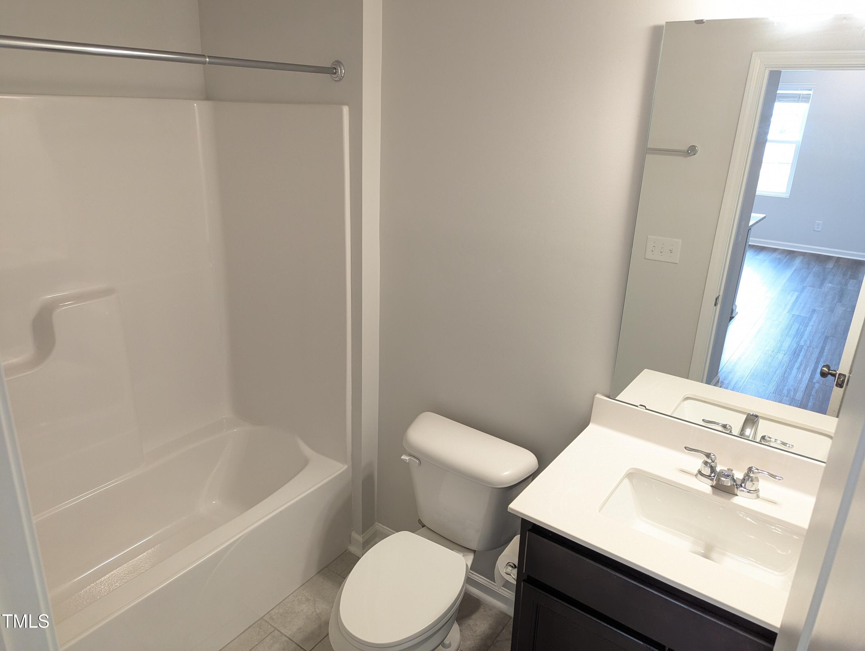 4020 Whitney Peak Drive Raleigh, NC 27616 - Photo 10 of 21 a bathroom with a sink toilet and shower