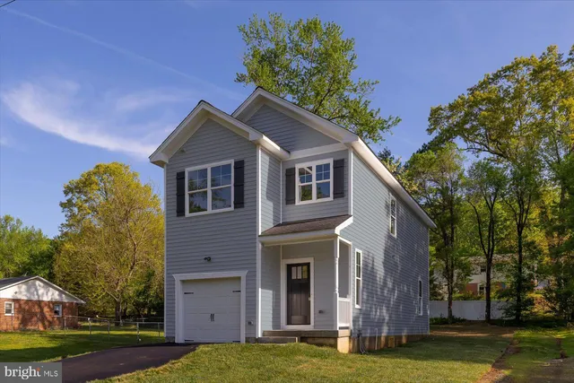 a house that has a tree in front of the house