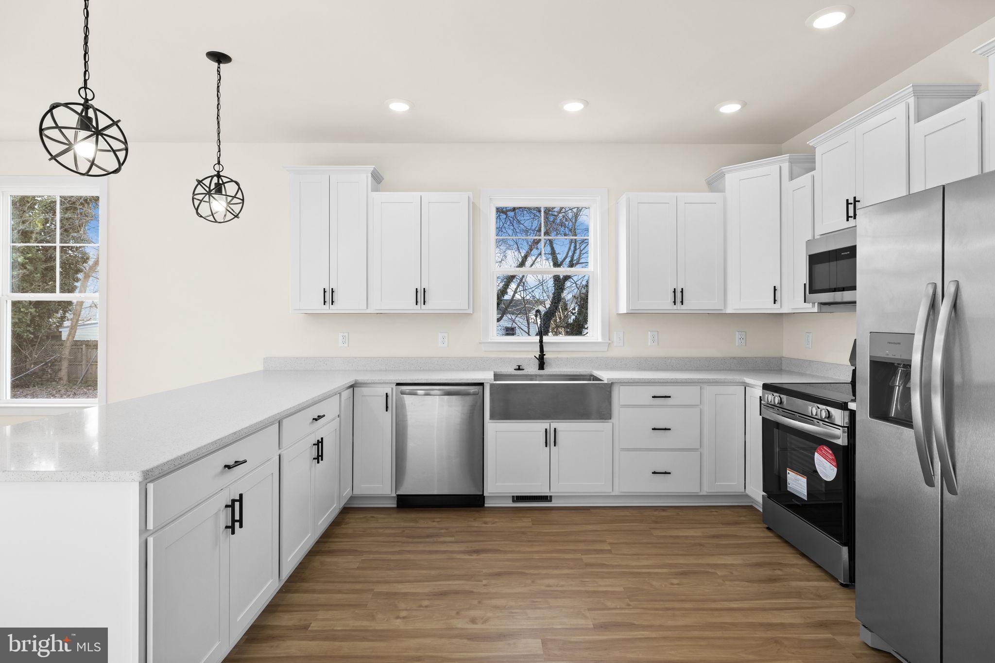 165 Bend Farm Road Fredericksburg, VA 22408 - Photo 14 of 51 a kitchen with white cabinets and stainless steel appliances