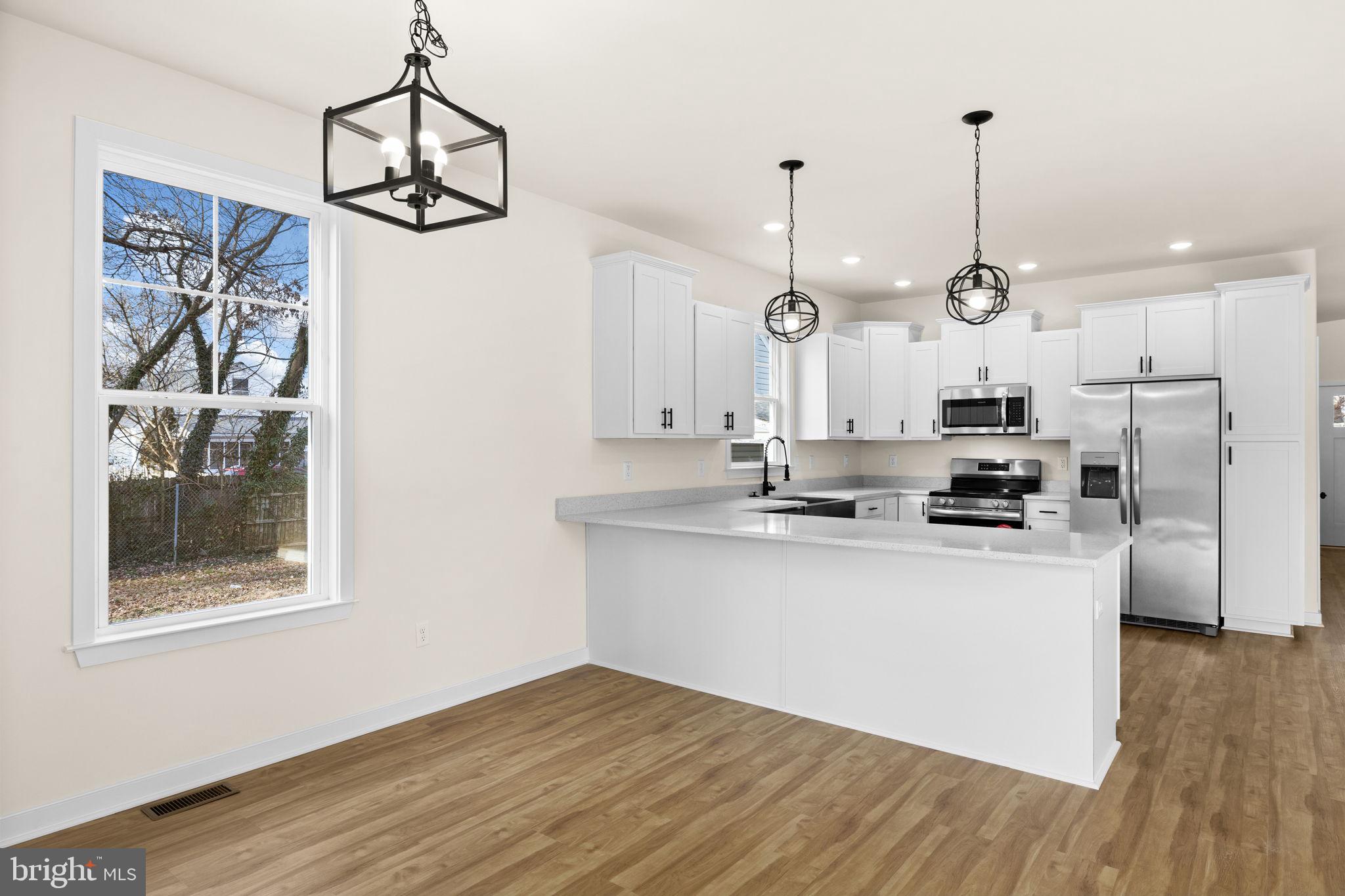 165 Bend Farm Road Fredericksburg, VA 22408 - Photo 22 of 51 a kitchen with stainless steel appliances kitchen island a refrigerator and a view of living room