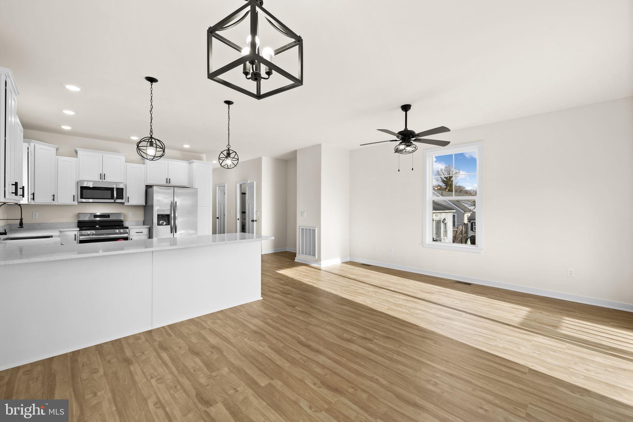 165 Bend Farm Road Fredericksburg, VA 22408 - Photo 24 of 51 a view of a kitchen with wooden floor and a ceiling fan