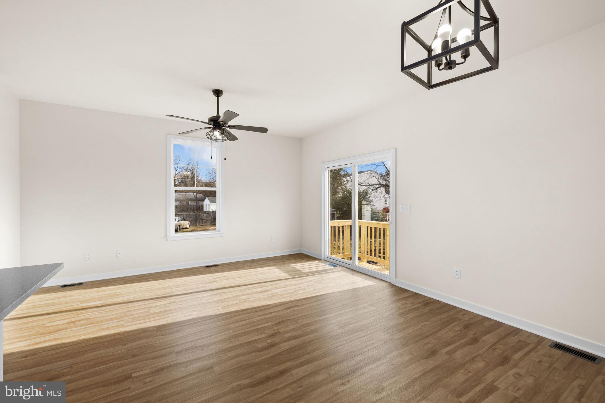 165 Bend Farm Road Fredericksburg, VA 22408 - Photo 25 of 51 an empty room with wooden floor chandelier and windows