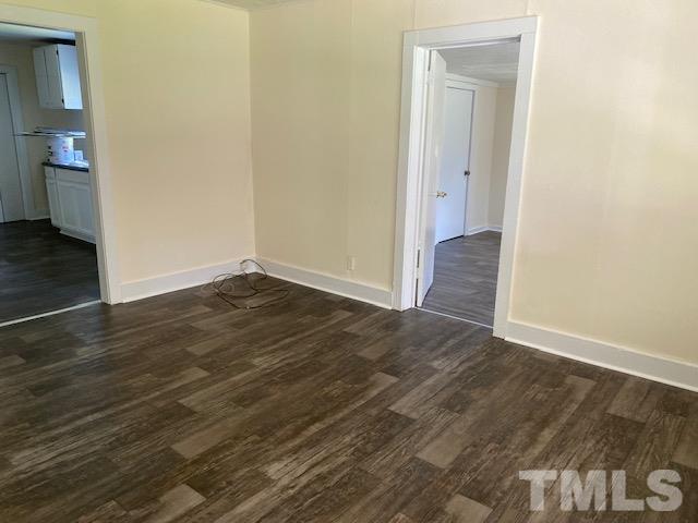 122 Bill Spain Road Henderson, NC 27537 - Photo 2 of 14 a view of an empty room with wooden floor and a bathroom