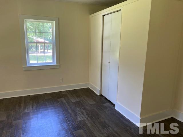 122 Bill Spain Road Henderson, NC 27537 - Photo 5 of 14 a view of an empty room with wooden floor and a window