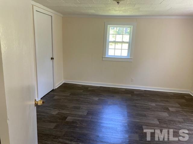 122 Bill Spain Road Henderson, NC 27537 - Photo 6 of 14 an empty room with wooden floor and windows