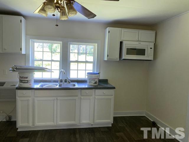 122 Bill Spain Road Henderson, NC 27537 - Photo 8 of 14 a kitchen with stainless steel appliances a microwave a stove and white cabinets