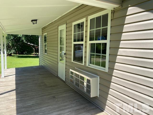 122 Bill Spain Road Henderson, NC 27537 - Photo 10 of 14 a view of a porch with wooden floor and stairs
