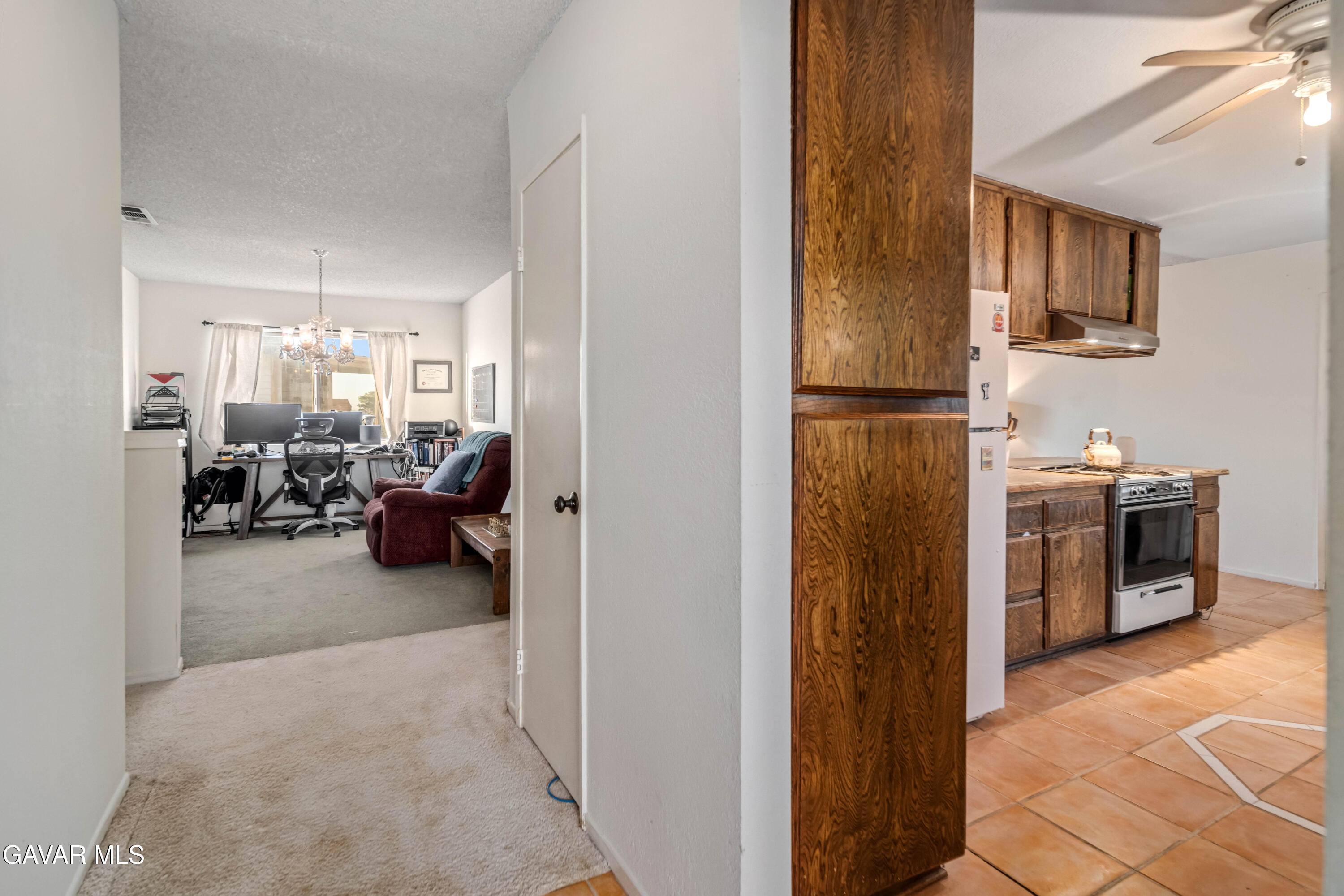 20539 East Ave R Palmdale, CA 93591 - Photo 17 of 55 a living room with furniture a flat screen tv and a refrigerator