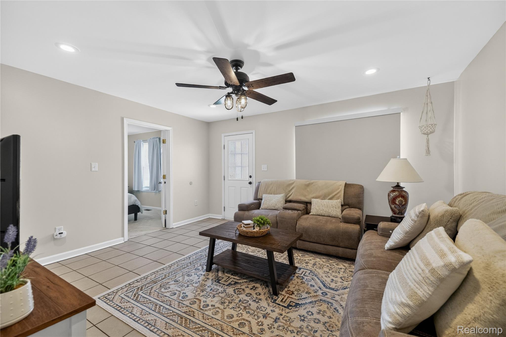 826 Goddard Road Wyandotte, MI 48192 - Photo 13 of 39 Recessed lighting, ceiling fan with integrated light, tile flooring, and a white paneled door