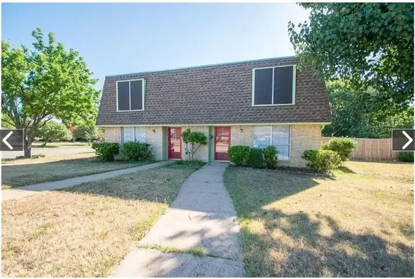 a front view of a house with a yard and a garage