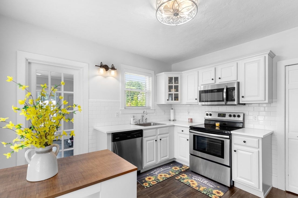 1012 Washington Street Whitman, MA 02382 - Photo 25 of 37 a kitchen with a sink a stove and cabinets