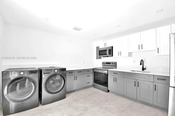 a view of kitchen sink and stove top oven