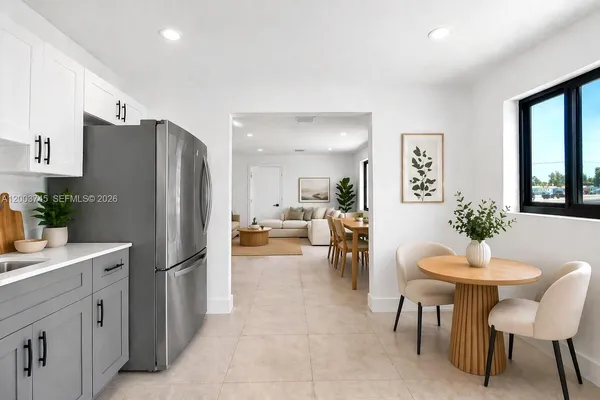 a kitchen with a refrigerator and table