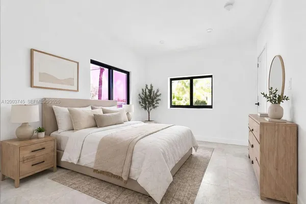a bedroom with a bed and a dresser with mirror