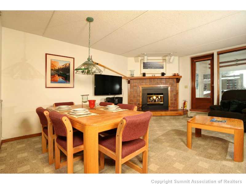 800 Copper Road, Unit 285 Copper Mountain, CO 80443 - Photo 2 of 17 a view of a dining room with furniture window and a fireplace