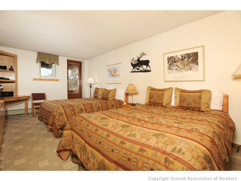 800 Copper Road, Unit 285 Copper Mountain, CO 80443 - Photo 11 of 17 a bedroom with a bed and wooden floor