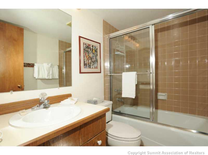 800 Copper Road, Unit 285 Copper Mountain, CO 80443 - Photo 13 of 17 a bathroom with a sink mirror and a shower