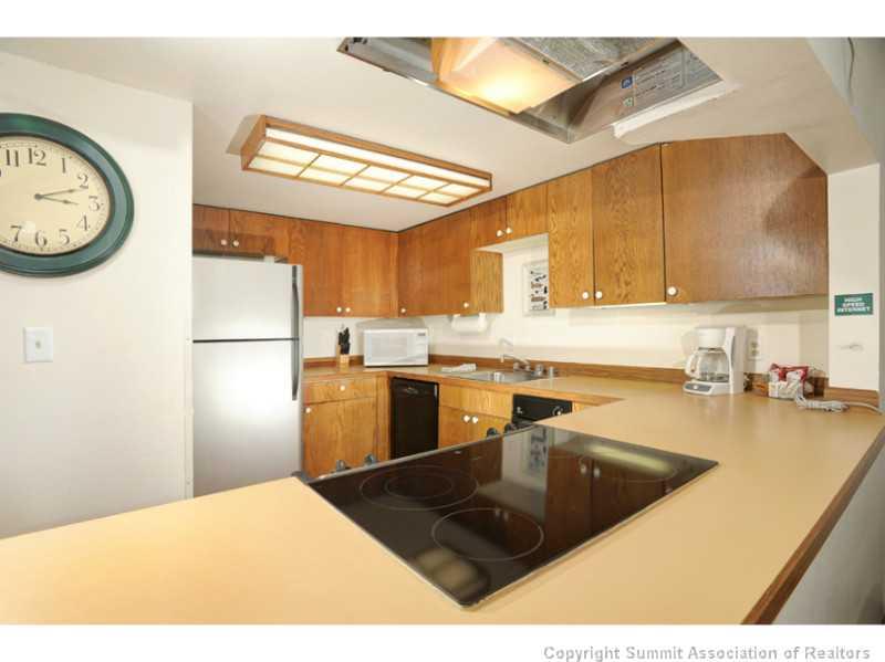 800 Copper Road, Unit 285 Copper Mountain, CO 80443 - Photo 4 of 17 a kitchen with stainless steel appliances granite countertop a sink a stove and refrigerator