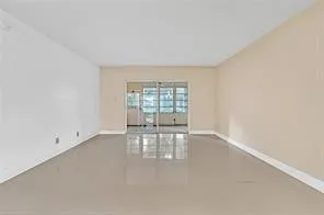 a bedroom with a bed lamp and a potted plant