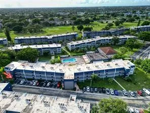 a kitchen with granite countertop a refrigerator and a stove