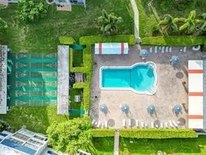 a kitchen with granite countertop stainless steel appliances white cabinets and a stove top oven