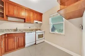a kitchen with stainless steel appliances granite countertop a refrigerator stove a sink and dishwasher