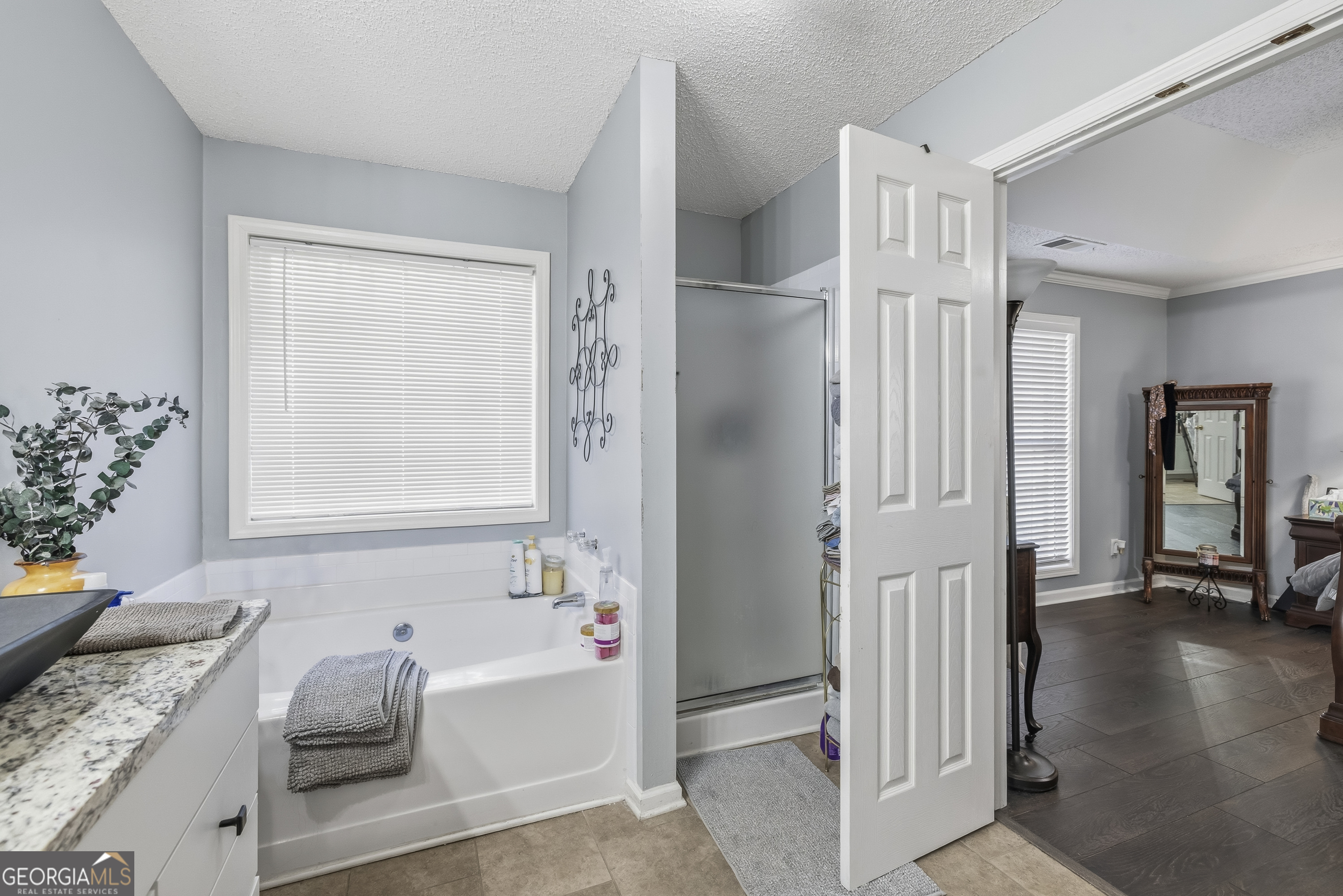 460 Flyway Lane Winder, GA 30680 - Photo 20 of 32 a bathroom with a tub sink and mirror