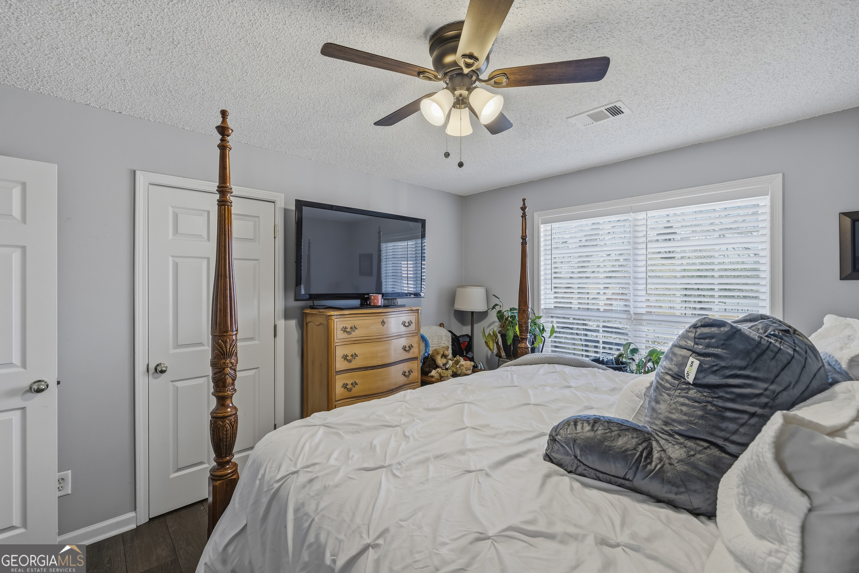 460 Flyway Lane Winder, GA 30680 - Photo 22 of 32 a bedroom with a bed flat screen tv and a window