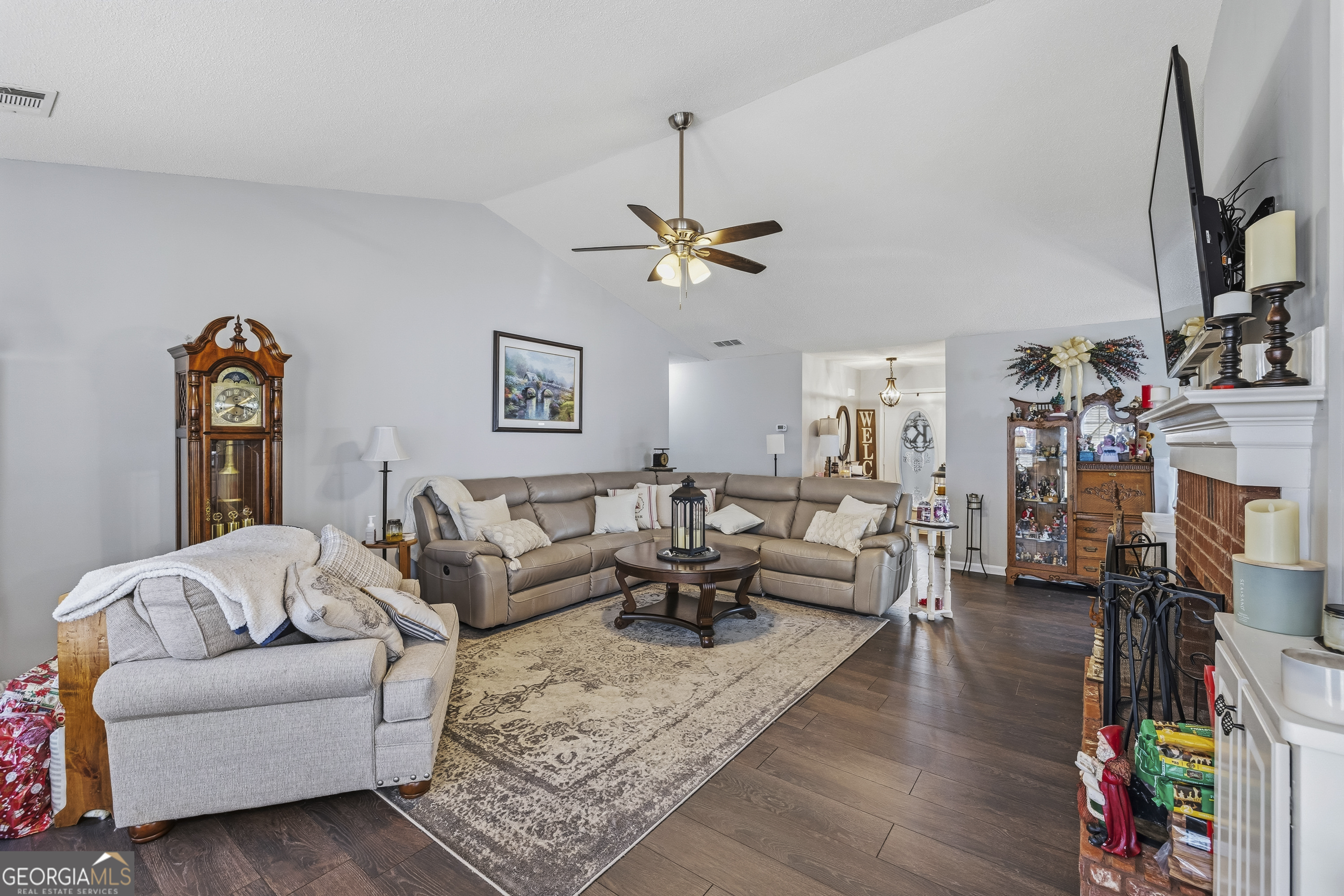 460 Flyway Lane Winder, GA 30680 - Photo 8 of 32 a living room with furniture a fireplace and a flat screen tv