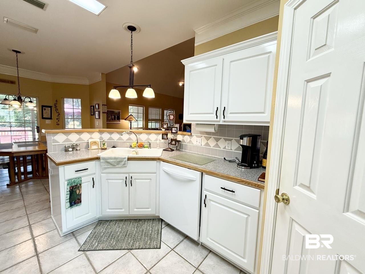 8091 Majors Court Daphne, AL 36526 - Photo 15 of 35 Kitchen with peninsula, white cabinetry, and decorative light fixtures